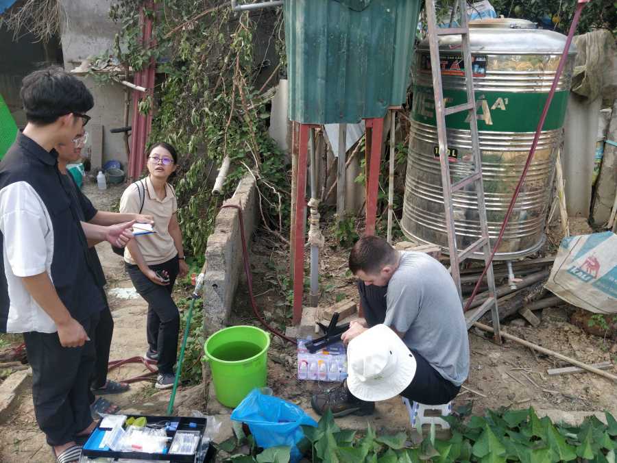 DeltAs vrew taking water samples at a rural backyard